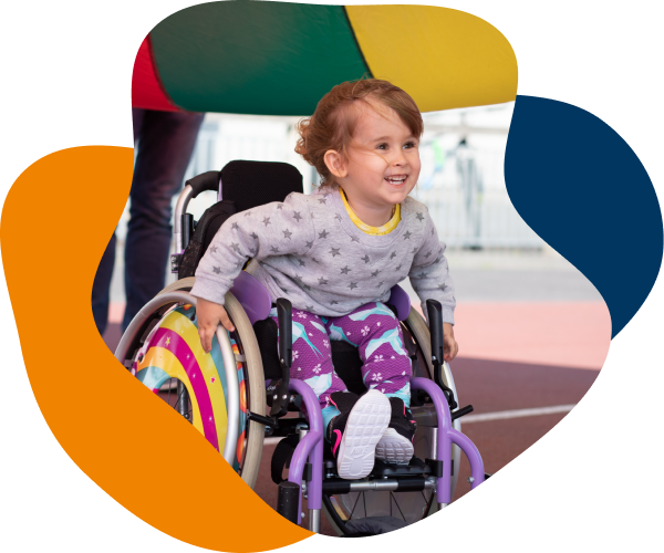 Smiling young girl in a wheelchair who is an SBHI service user.